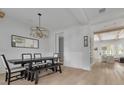 Bright dining room featuring a large table, bench seating, and elegant chandelier at 4306 W Barcelona St, Tampa, FL 33629