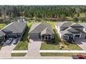 Aerial view of houses in a residential community with a pond nearby at 4661 Southern Valley Loop, Brooksville, FL 34601