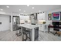 Modern kitchen with stainless steel appliances, island, and granite countertops at 4900 Brittany S Dr # 409, St Petersburg, FL 33715