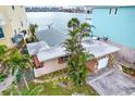 Charming waterfront home with pink exterior and lush landscaping at 501 180Th E Ave, Redington Shores, FL 33708