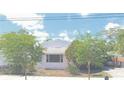 Charming single-story home with lush landscaping, a covered carport, and a well-maintained front yard at 509 Rosery Nw Rd, Largo, FL 33770