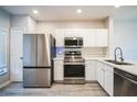 Modern kitchen with stainless steel appliances and white cabinets at 10157 Bessemer Pond Ct, Riverview, FL 33578