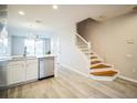 Modern kitchen with island and staircase leading upstairs at 10157 Bessemer Pond Ct, Riverview, FL 33578