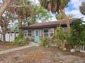 Charming bungalow with teal door and stone accents at 13225 2Nd E St, Madeira Beach, FL 33708