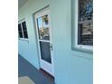 Condo building entry with a light teal exterior and glass door at 1819 Shore S Dr # 203, South Pasadena, FL 33707