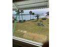 Scenic view of a calm body of water with lush greenery from a window at 1819 Shore S Dr # 203, South Pasadena, FL 33707
