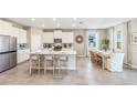 Spacious kitchen with island, white cabinetry, and dining area at 3548 Thistle Bank Ct, Plant City, FL 33565
