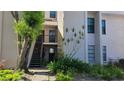 Exterior view of condo building with stairs, landscaping, and building number visible at 4745 Puritan Cir # 4745, Tampa, FL 33617