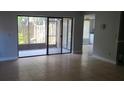 Living room with tile floors and sliding glass doors leading to a patio at 4745 Puritan Cir # 4745, Tampa, FL 33617