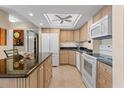 Bright kitchen featuring granite countertops and white cabinets at 4900 Brittany S Dr # 1512, St Petersburg, FL 33715
