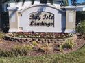 Community entrance sign for Bay Isle Landings with colorful flower bed at 5153 Bay Isle Cir, Clearwater, FL 33760