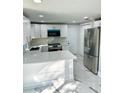 Modern kitchen with white cabinets and stainless steel appliances at 6220 Westport Dr, Port Richey, FL 34668