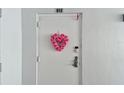 Inviting condo entry with heart-shaped floral wreath at 7 Elgin Pl # 812, Dunedin, FL 34698