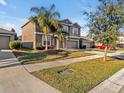 Two-story house with palm trees and a driveway at 8506 Hunters Fork Loop, Ruskin, FL 33573