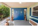 Inviting entryway with double blue doors and a cozy porch at 8537 Cameo Dr, New Port Richey, FL 34654