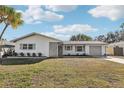 Newly renovated light-grey house with a well maintained lawn at 10904 90Th Ter, Seminole, FL 33772