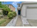 Landscaped front yard with walkway leading to the front door of the house at 1107 Seminole Sky Dr, Ruskin, FL 33570
