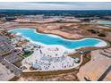 Aerial view of a crystal lagoon with beach and surrounding amenities at 11307 Linden Depot Rd, San Antonio, FL 33576