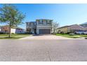 Two-story house with gray siding, solar panels, and a two-car garage at 11514 Brighton Knoll Loop, Riverview, FL 33579