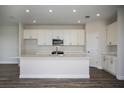 Spacious kitchen with white cabinets, quartz countertops, and stainless steel appliances at 12140 Cattleside Dr, Riverview, FL 33579