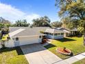 Nice curb appeal, single-story home with a landscaped yard and attached garage at 1626 Spottswood Cir, Palm Harbor, FL 34683