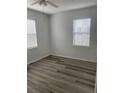 Bright bedroom featuring wood-look flooring and window blinds at 18001 Richmond Place Dr # 125, Tampa, FL 33647