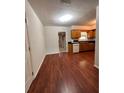 Bright dining area with wood flooring and an open view to the kitchen at 1916 Macomber Ave, Clearwater, FL 33755