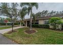 House exterior showcasing landscaping and driveway at 2035 Hampstead Cir # 275, Sun City Center, FL 33573