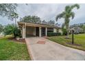 Front view of single-story home with carport and landscaped yard at 2035 Hampstead Cir # 275, Sun City Center, FL 33573