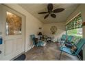 Cozy screened porch with seating and ceiling fan at 2035 Hampstead Cir # 275, Sun City Center, FL 33573