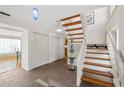 Bright entryway with tiled floors and a wooden staircase at 2781 Westchester Dr S, Clearwater, FL 33761