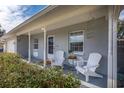 Inviting front porch with comfy chairs, perfect for relaxing at 3116 Winchester Dr, Dunedin, FL 34698