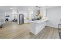 Modern kitchen featuring white cabinets, stainless steel appliances, and a breakfast bar at 5718 Magnolia N St, St Petersburg, FL 33703