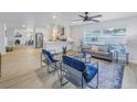 Open concept living and kitchen area with light flooring and modern furniture at 5718 Magnolia N St, St Petersburg, FL 33703