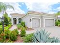 Beautiful home with a three-car garage and nicely landscaped front yard at 1069 River Wind Cir, Bradenton, FL 34212