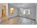 Bright dining room with gray walls, wood-look tile floor, and a chandelier at 1702 Horseshoe Dr, Plant City, FL 33566
