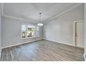 Bright dining room with gray walls, wood-look tile floors, and a chandelier at 1702 Horseshoe Dr, Plant City, FL 33566