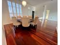 Elegant dining room with hardwood floors, chandelier, and a round table with six chairs at 19809 Wyndham Lakes Dr, Odessa, FL 33556