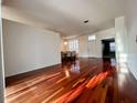 Spacious living room featuring hardwood floors and view into the dining area at 19809 Wyndham Lakes Dr, Odessa, FL 33556