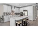 A kitchen island with seating complements this stylish and functional space at 19891 Bridgetown Loop, Venice, FL 34293