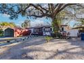 Home exterior showcasing landscaping and carport at 2005 E Crenshaw St, Tampa, FL 33610