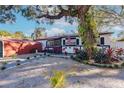 House exterior featuring walkway, landscaping, and large tree at 2005 E Crenshaw St, Tampa, FL 33610