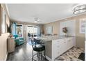 Open kitchen with granite island and white cabinets at 2506 N Rocky Point Dr # 204, Tampa, FL 33607