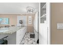 Kitchen with white cabinets, granite countertop and tile floor at 2506 N Rocky Point Dr # 204, Tampa, FL 33607