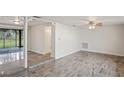Spacious living room featuring tiled floors and access to the backyard at 3403 Overland Dr, Holiday, FL 34691