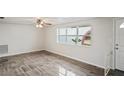 Open living area with large windows and tiled floors at 3403 Overland Dr, Holiday, FL 34691