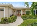Elegant entryway with double doors and landscaping at 3939 Venetian Way, Tampa, FL 33634