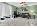 Living room with black leather couch and dining area at 4215 E Bay Dr # 1702A, Clearwater, FL 33764