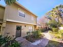 Two-story townhome with a landscaped front yard and a walkway at 7634 Desoto Ct, Tampa, FL 33615