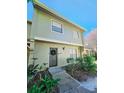 Two-story townhome with a landscaped front yard and a walkway at 7634 Desoto Ct, Tampa, FL 33615
